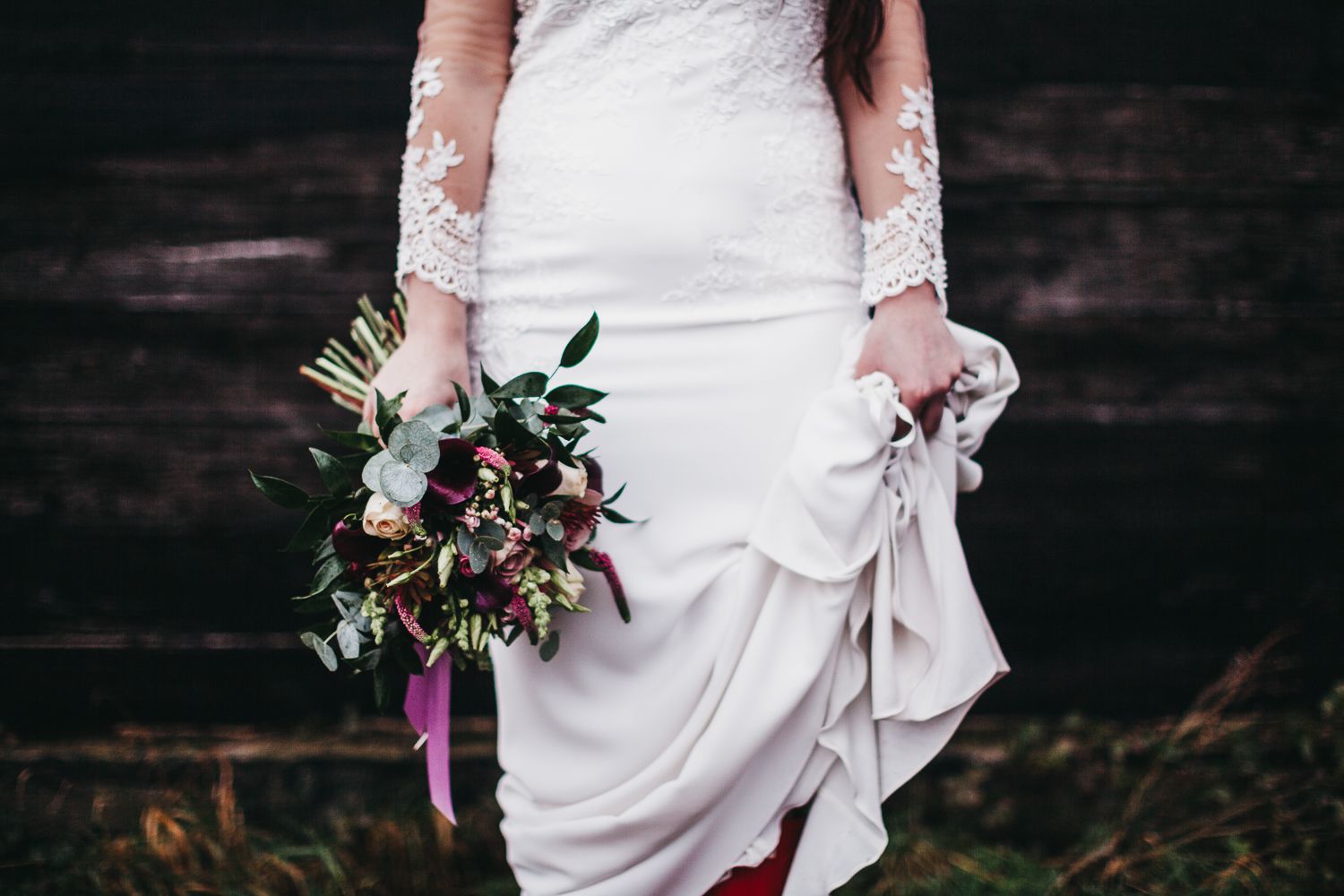 lower body image of bride holding a bouquet and her dress