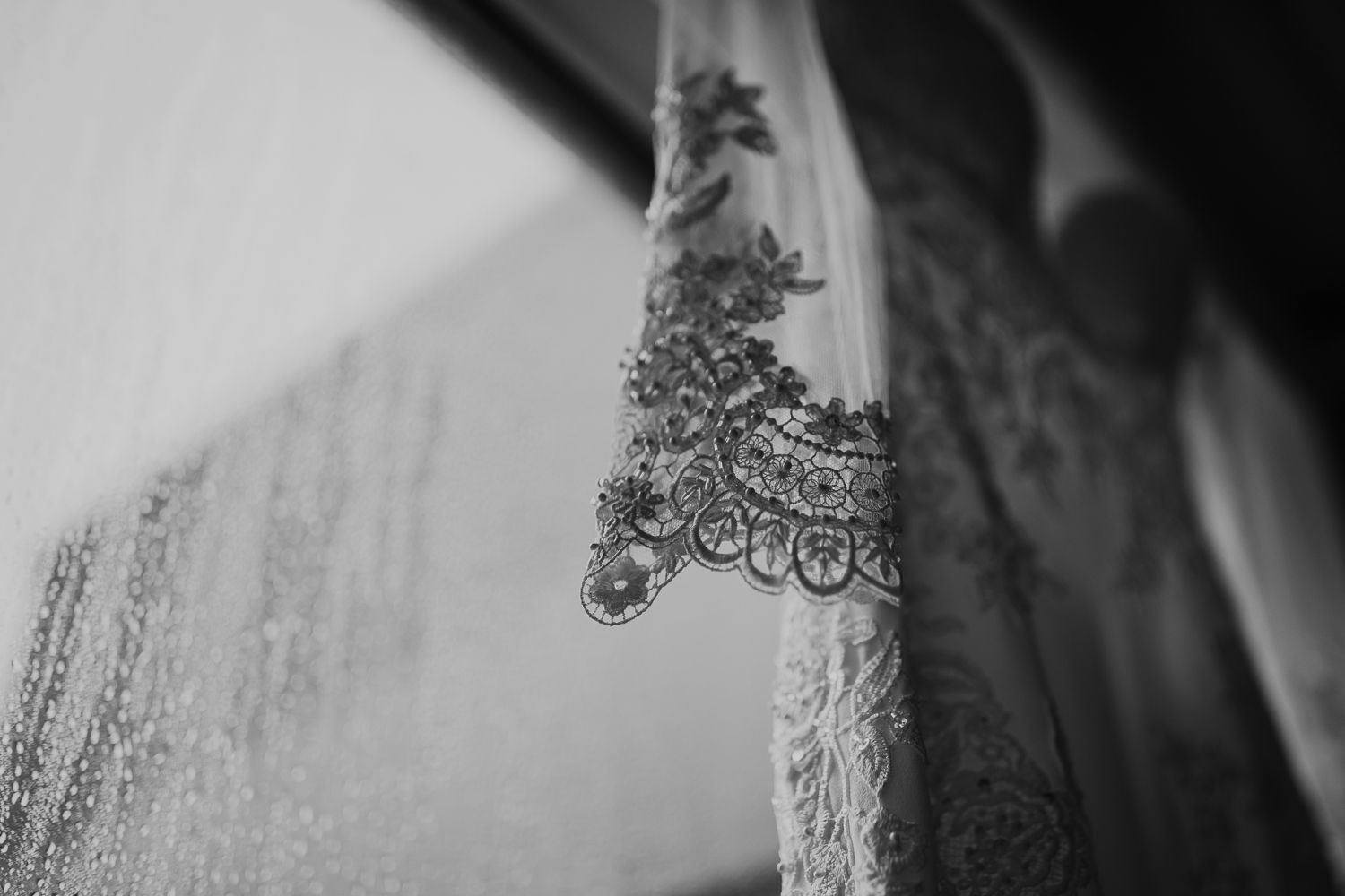 wedding dress in black and white against a rainy window