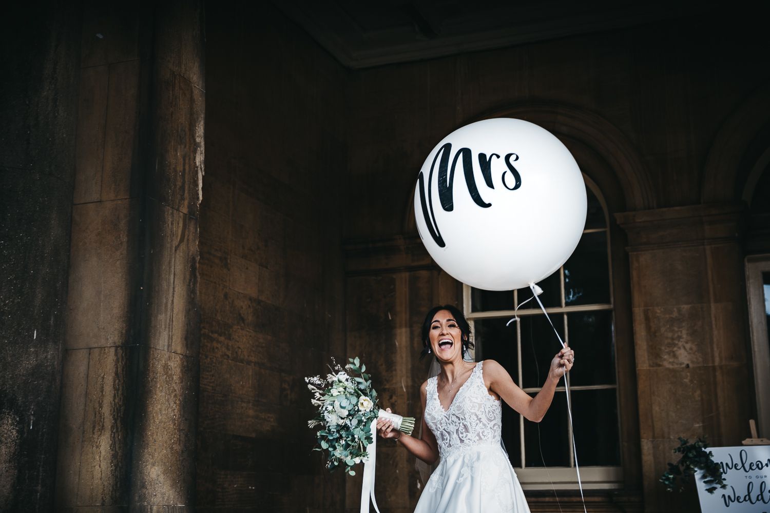 Bride with white balloon with the words Mrs written on it