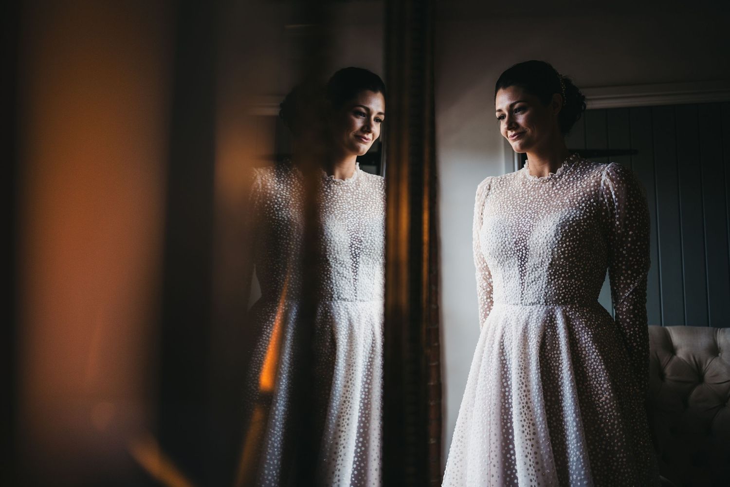 Bride stood in window of bridal suite at the west mill in derby