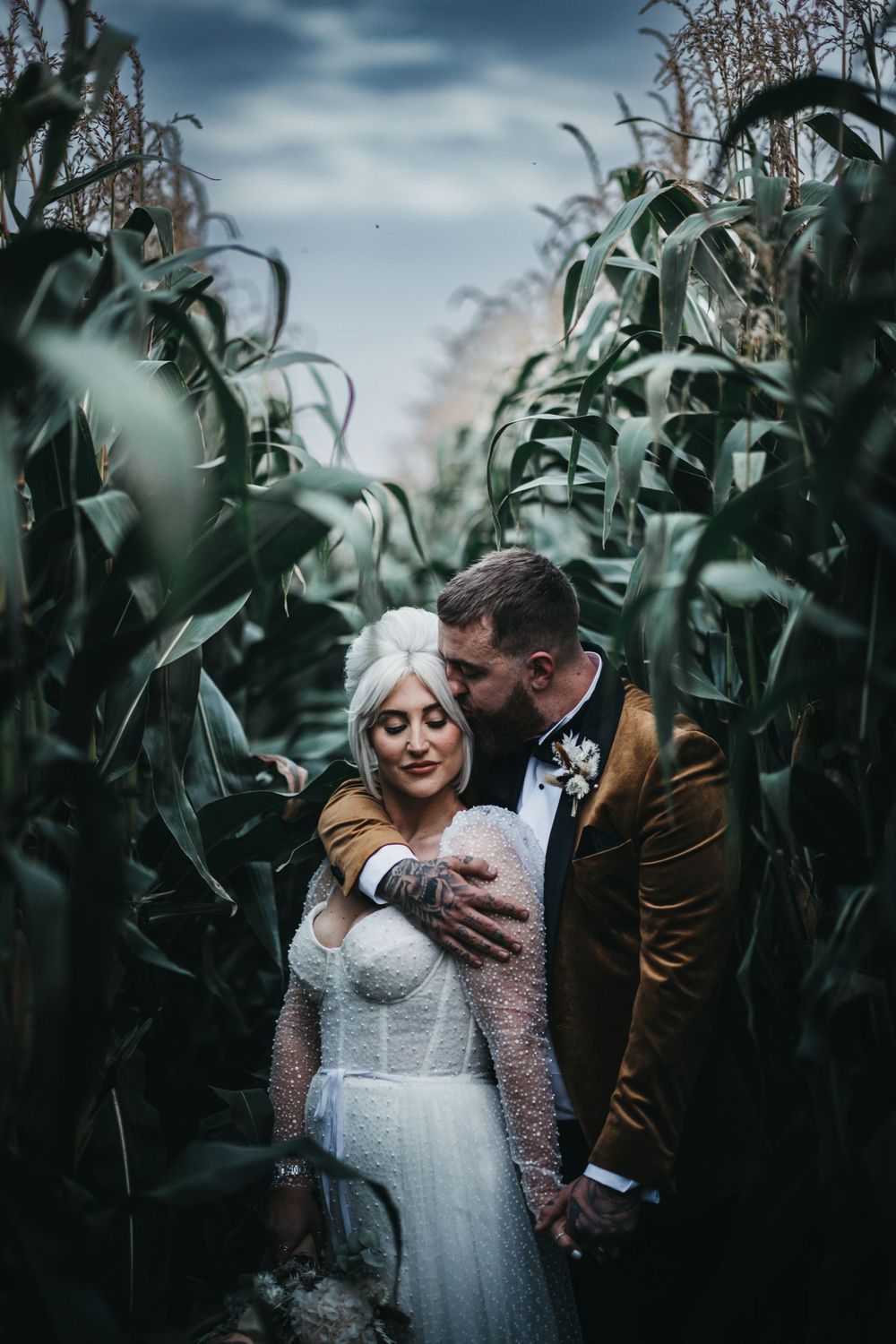 Bride and groom stood in corn field on their wedding day