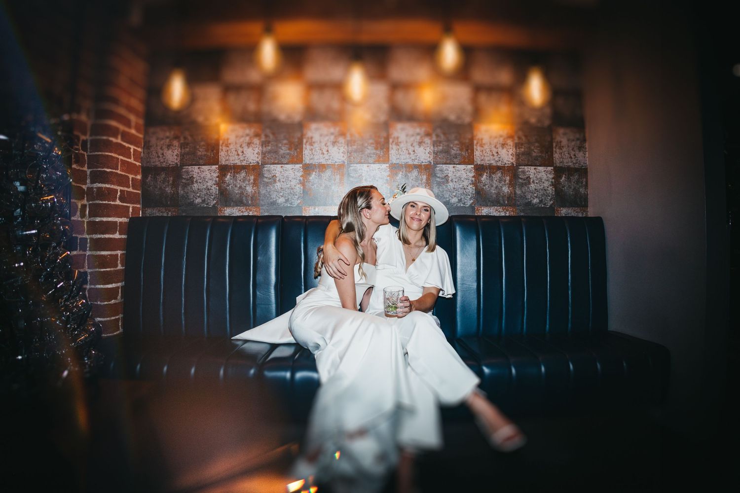 LGBT couple sat on sofa on their wedding day at Haarlem Mill