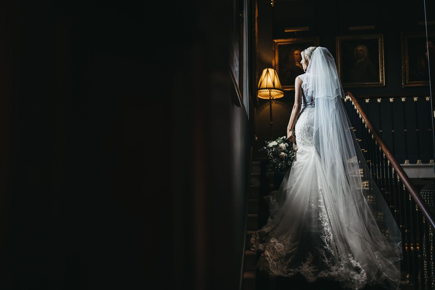 Bride's wedding dress shot while stood on stairs at Stubton Hall