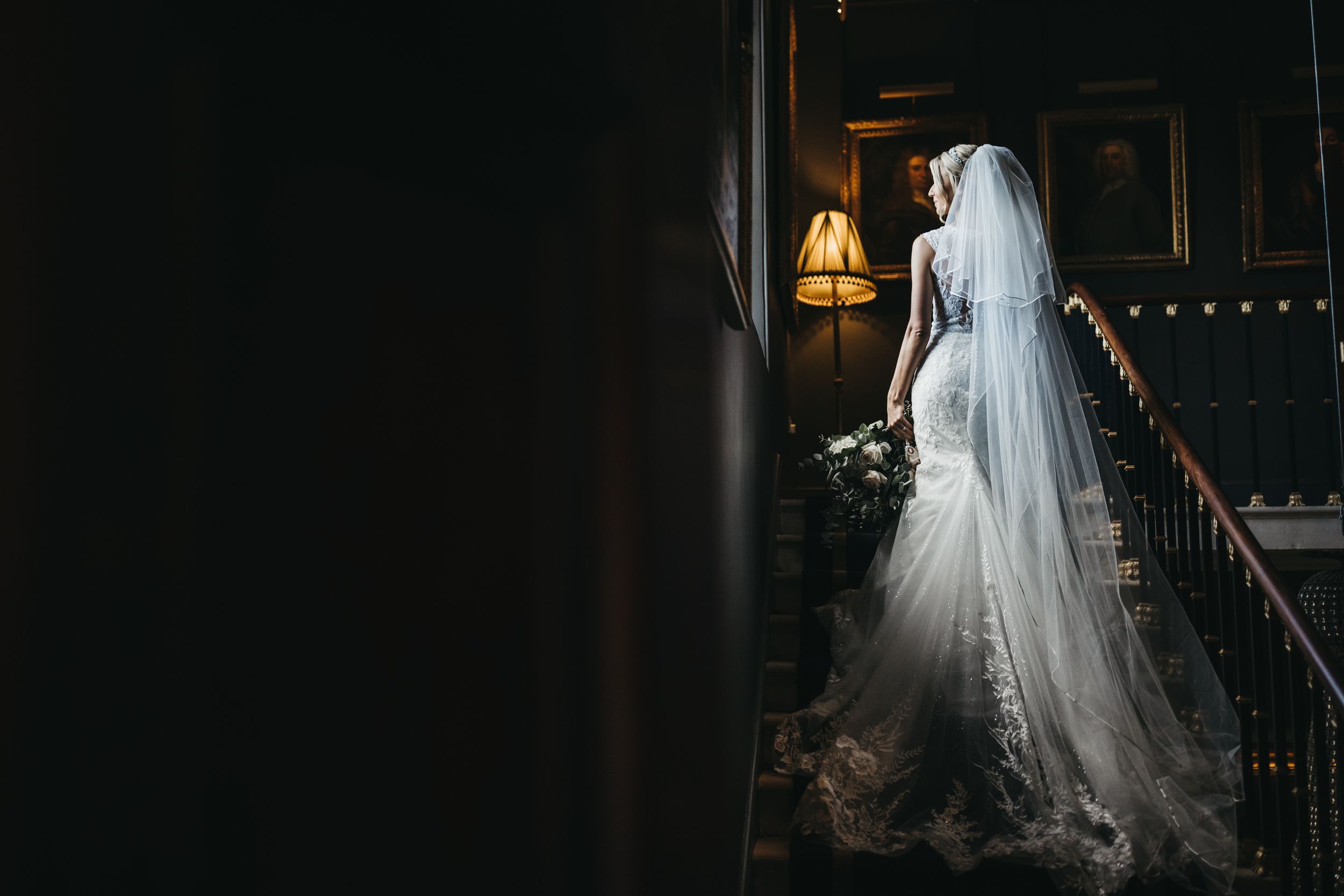 Bride's wedding dress shot while stood on stairs at Stubton Hall