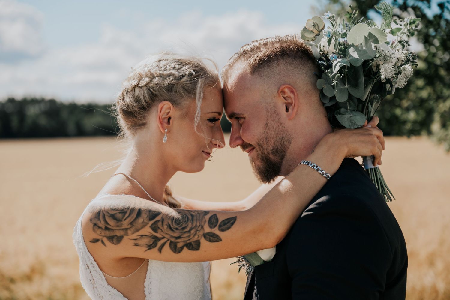 An intimate wedding portrait session in a golden wheat field.