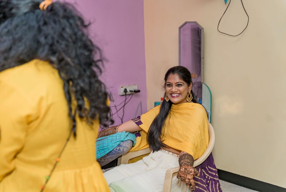 Two people share a candid moment during what appears to be a traditional celebration.