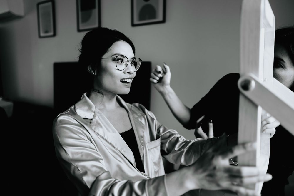 Behind-the-scenes preparation moments in a studio with natural light.