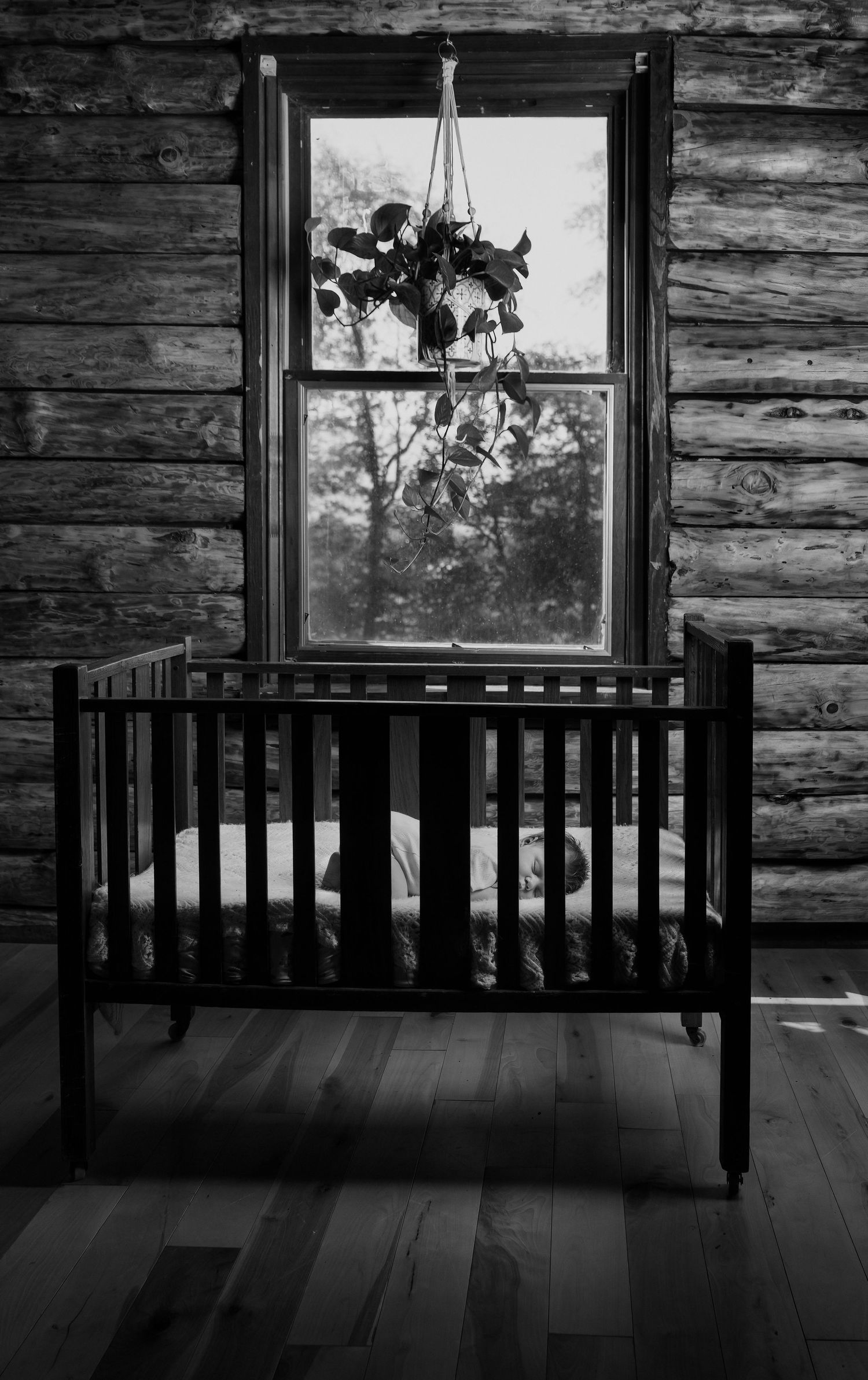 Newborn sleeps in heirloom crib