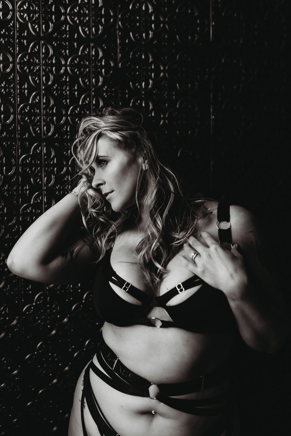 Monochrome intimate portrait showcasing curves and confidence in black lingerie.