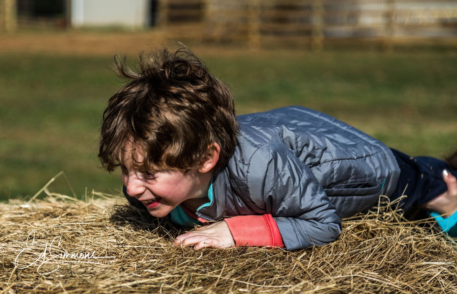 Family portrait of a young clild on a hay bale