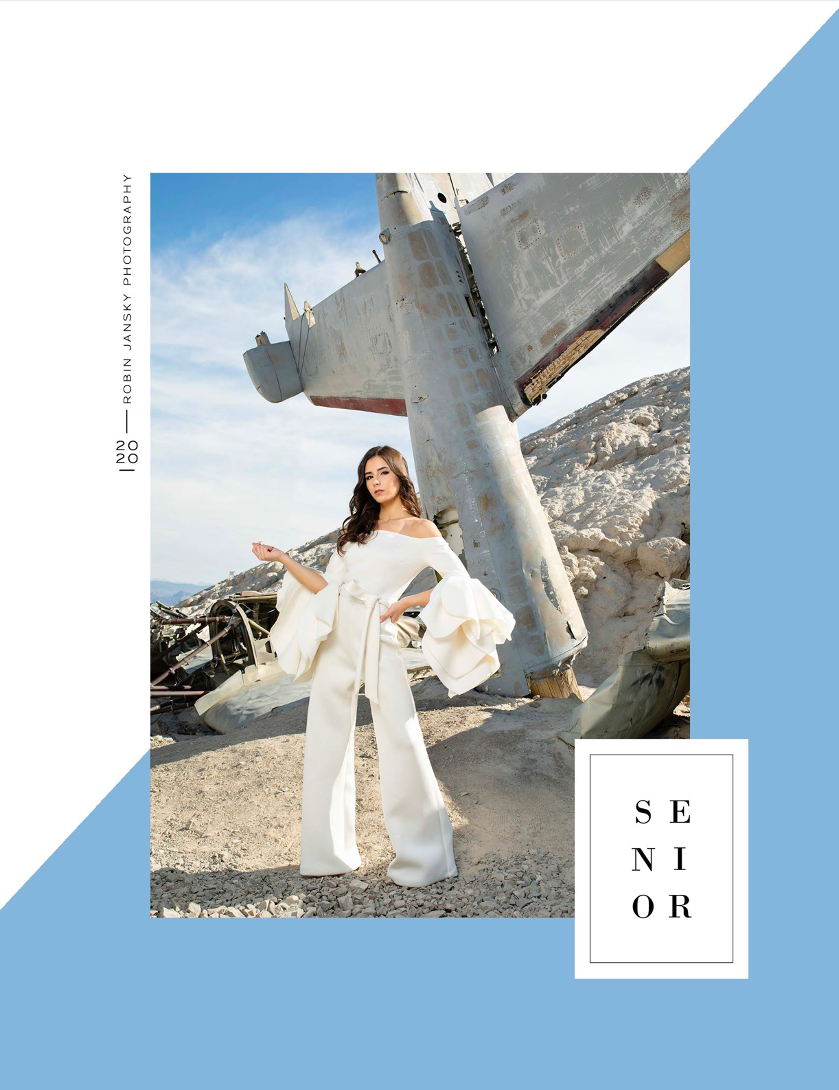 Fashion photography shoot featuring white pantsuit against vintage airplane backdrop.