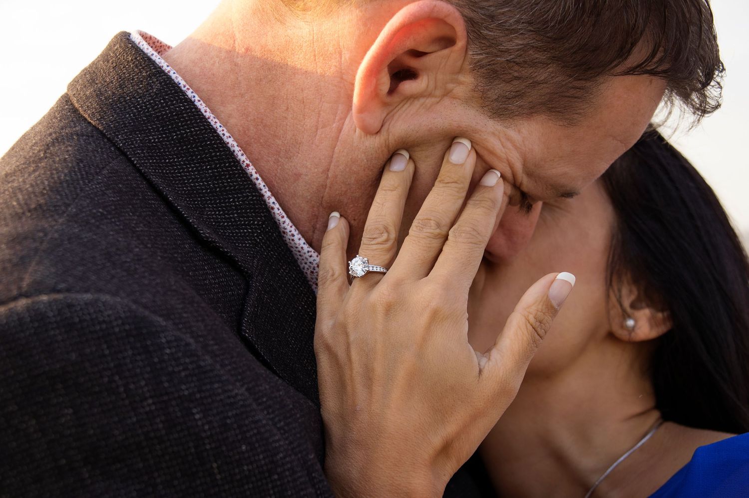 close up of diamond engagement ring on hand