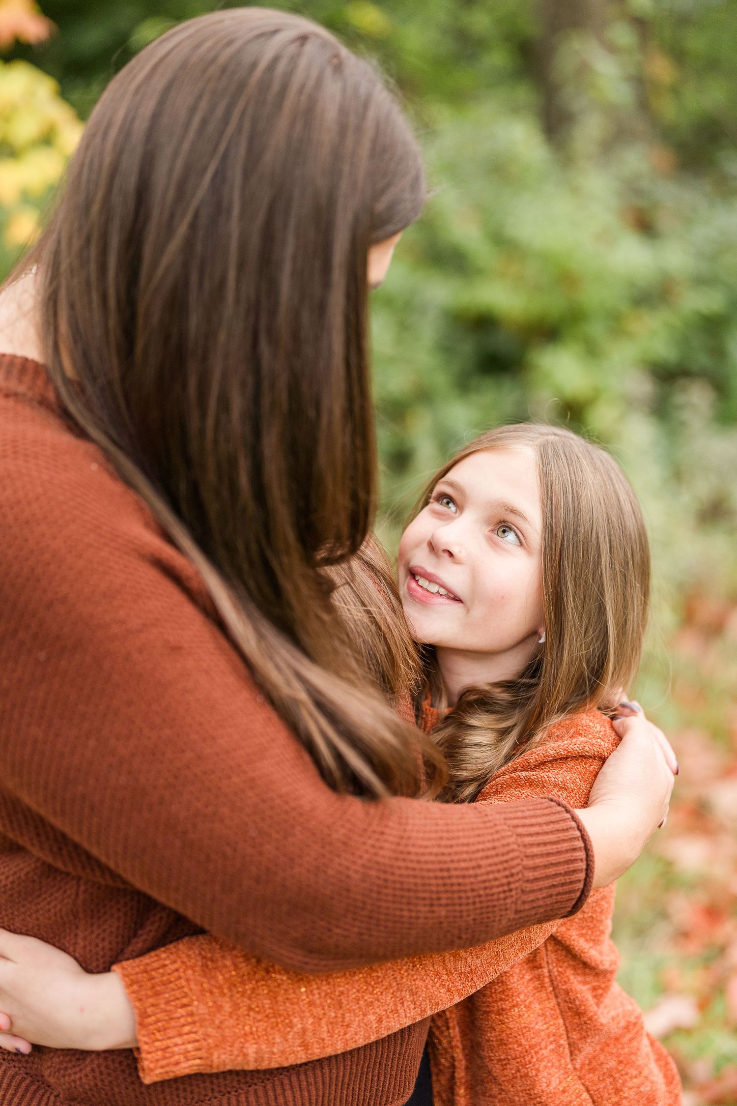 aunt and niece photoshoot at busse woods. standing in a field posing taken by a milwaukee wedding photographer