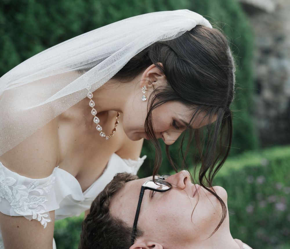 Romantic wedding couple sharing an intimate moment in a garden setting.
