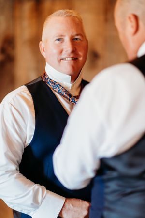 Wedding day preparation showing formal attire and detailed accessories.