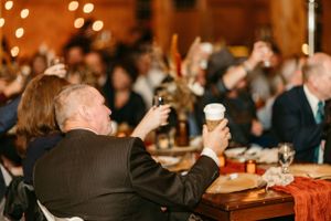 Wedding guests raise their glasses in celebration during the reception festivities.