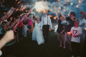 Sparkler exit celebration at night with wedding guests creating a magical atmosphere.