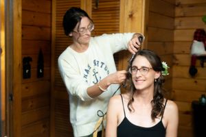 Getting ready scene in a wooden cabin with hair styling preparations.