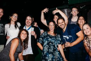 Wedding guests dance and celebrate during lively nighttime reception party.