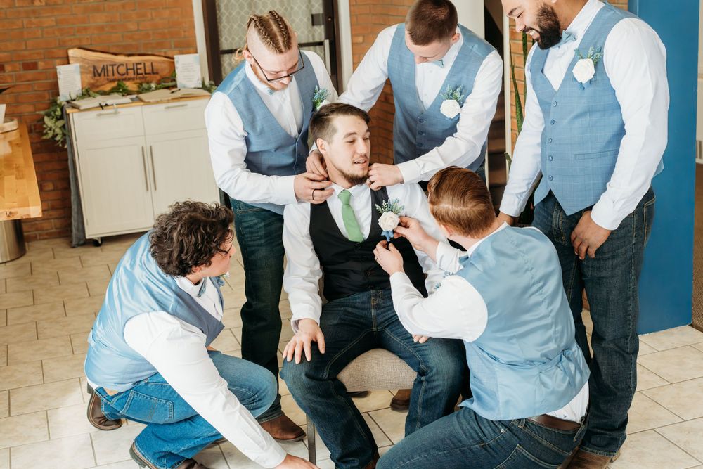 Groomsmen having fun and joking around before the wedding ceremony.