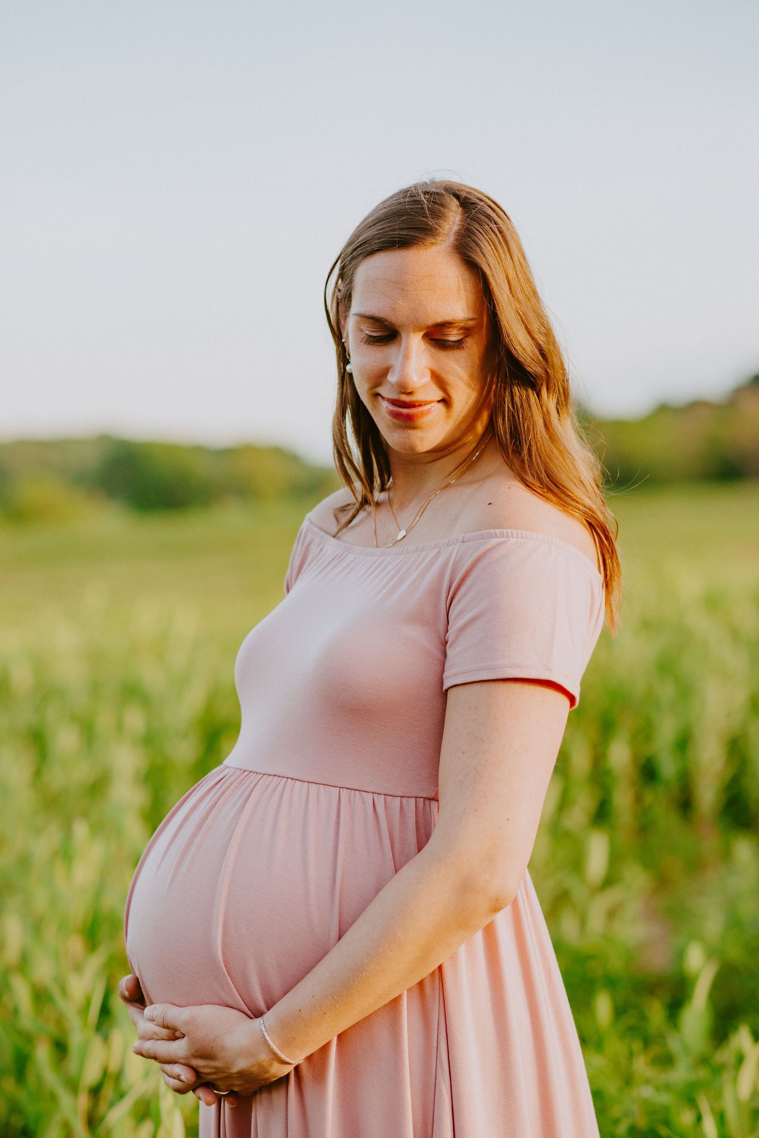 Mother to be in green field in Valley Forge Park