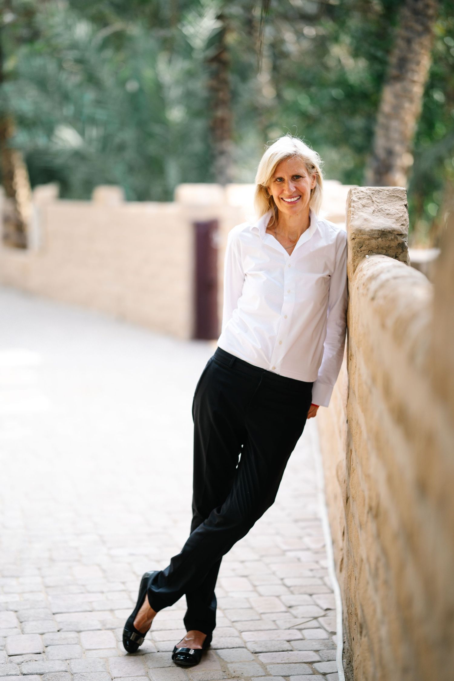 Artistic fashion photoshoot sequence showing casual white and black outfit against stone pathway.