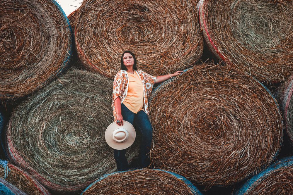 senior girl on the hay bales