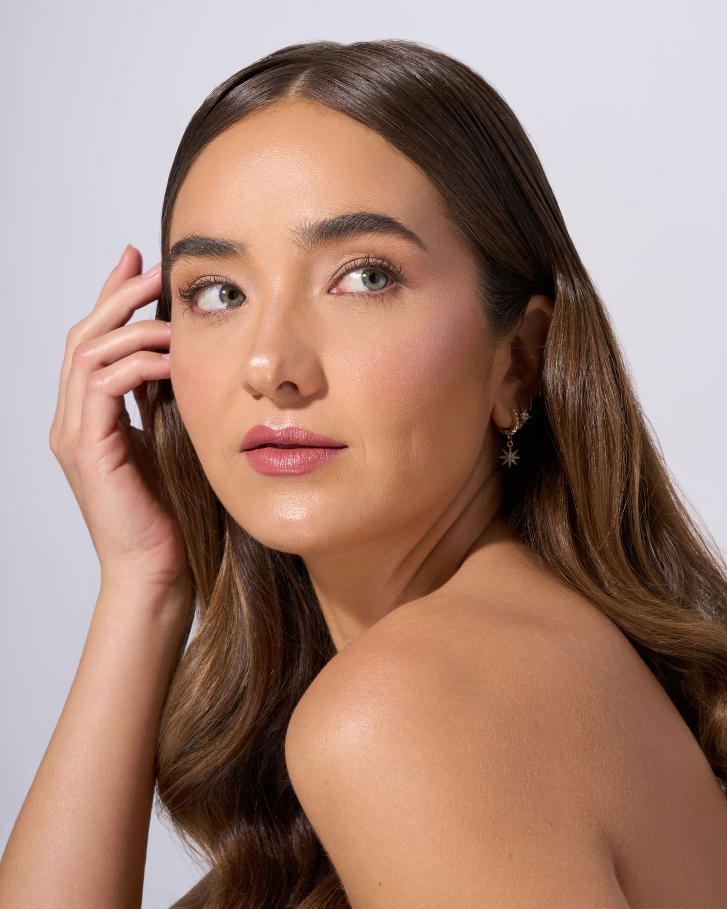 Close-up beauty headshot highlighting natural skin texture and makeup detail.