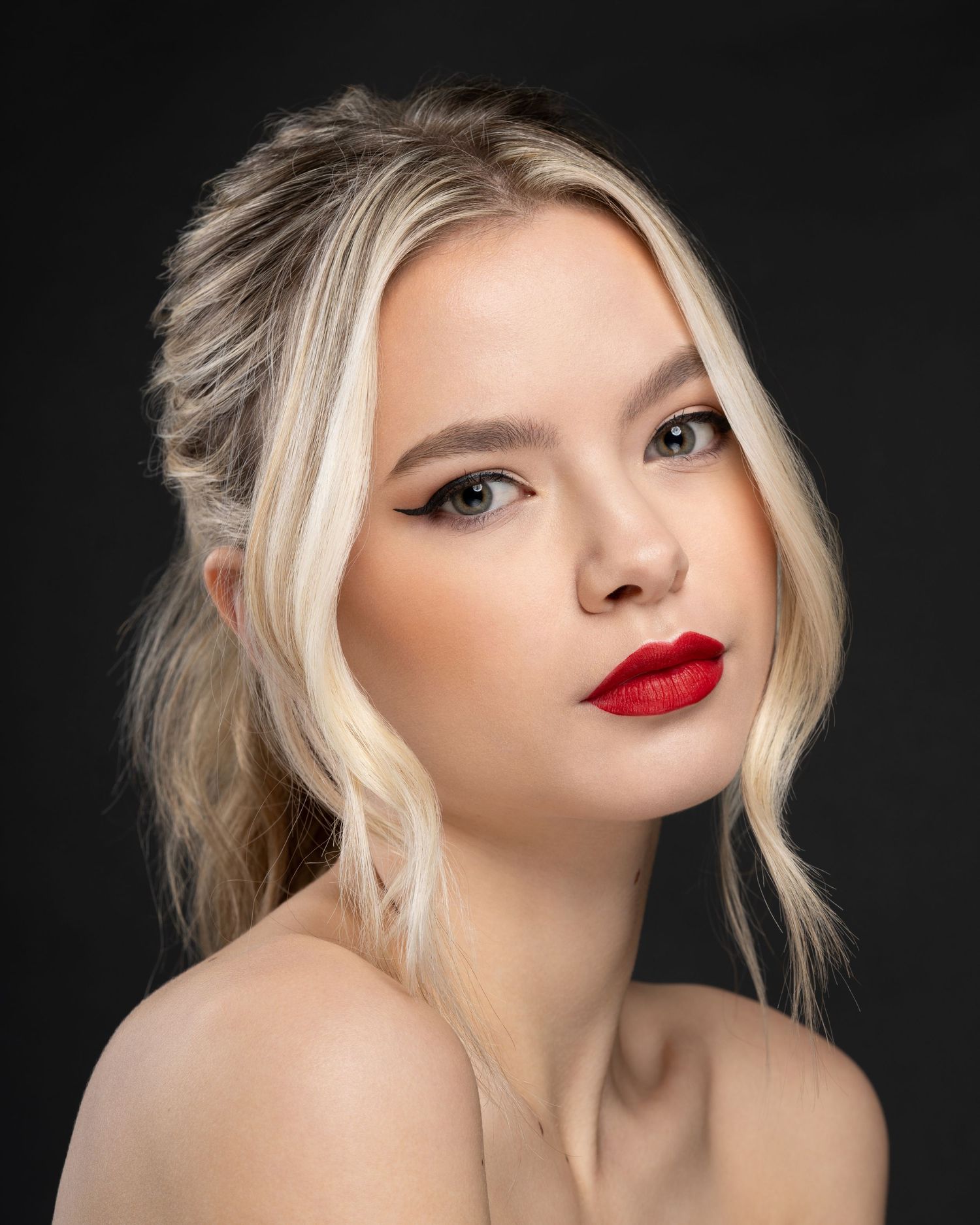 Studio beauty image featuring professional hair, makeup, and retouching.