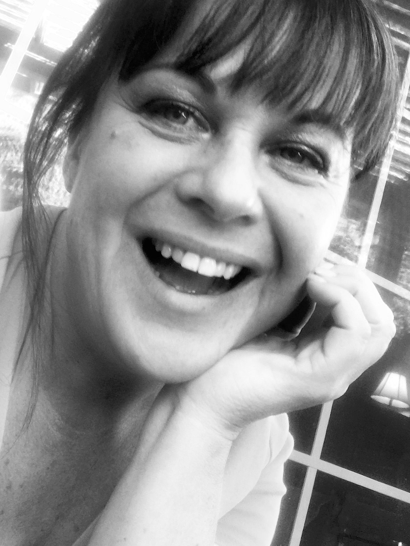 Black and white selfie showing joyful expression.