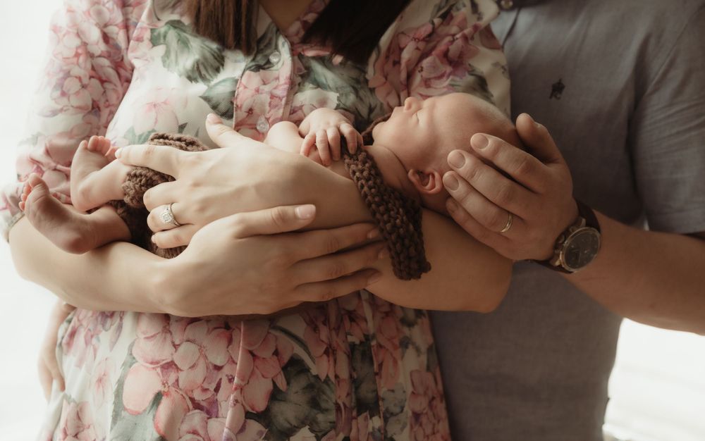 Newborn held in parents hands