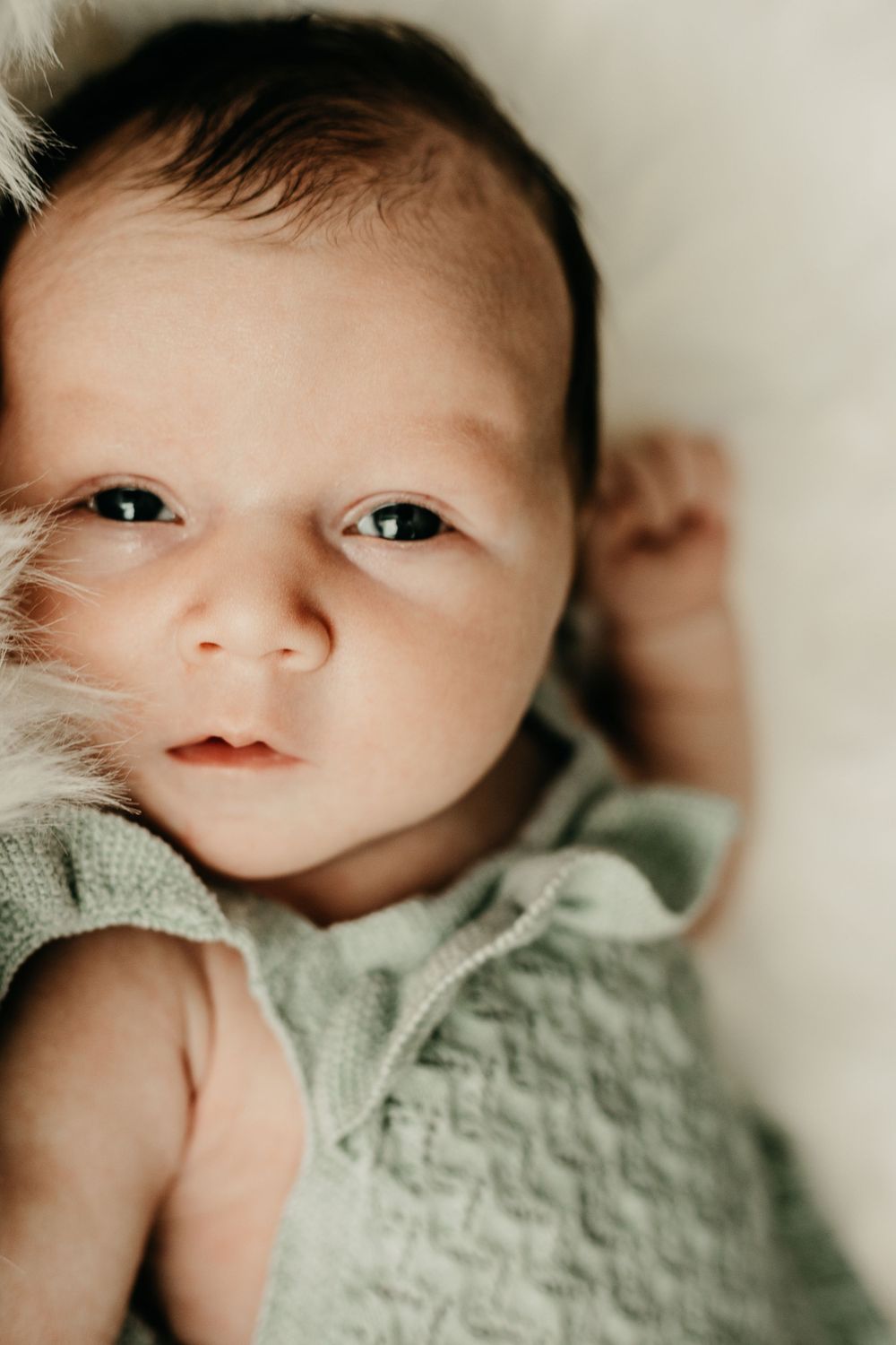Newborn baby looking at camera