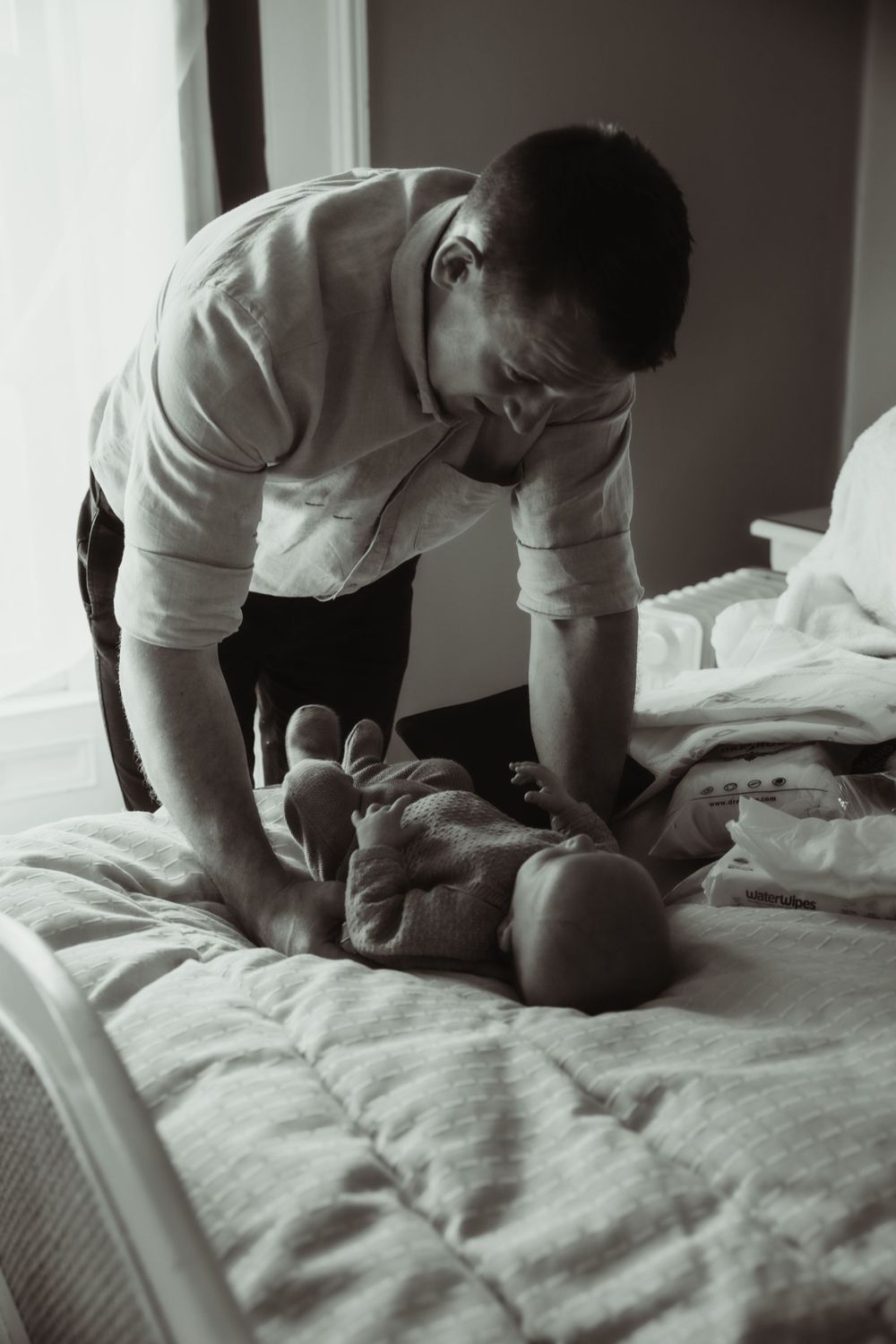 Newborn baby and father candid