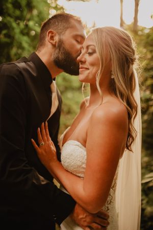 Intimate golden hour portrait of couple in wedding attire.