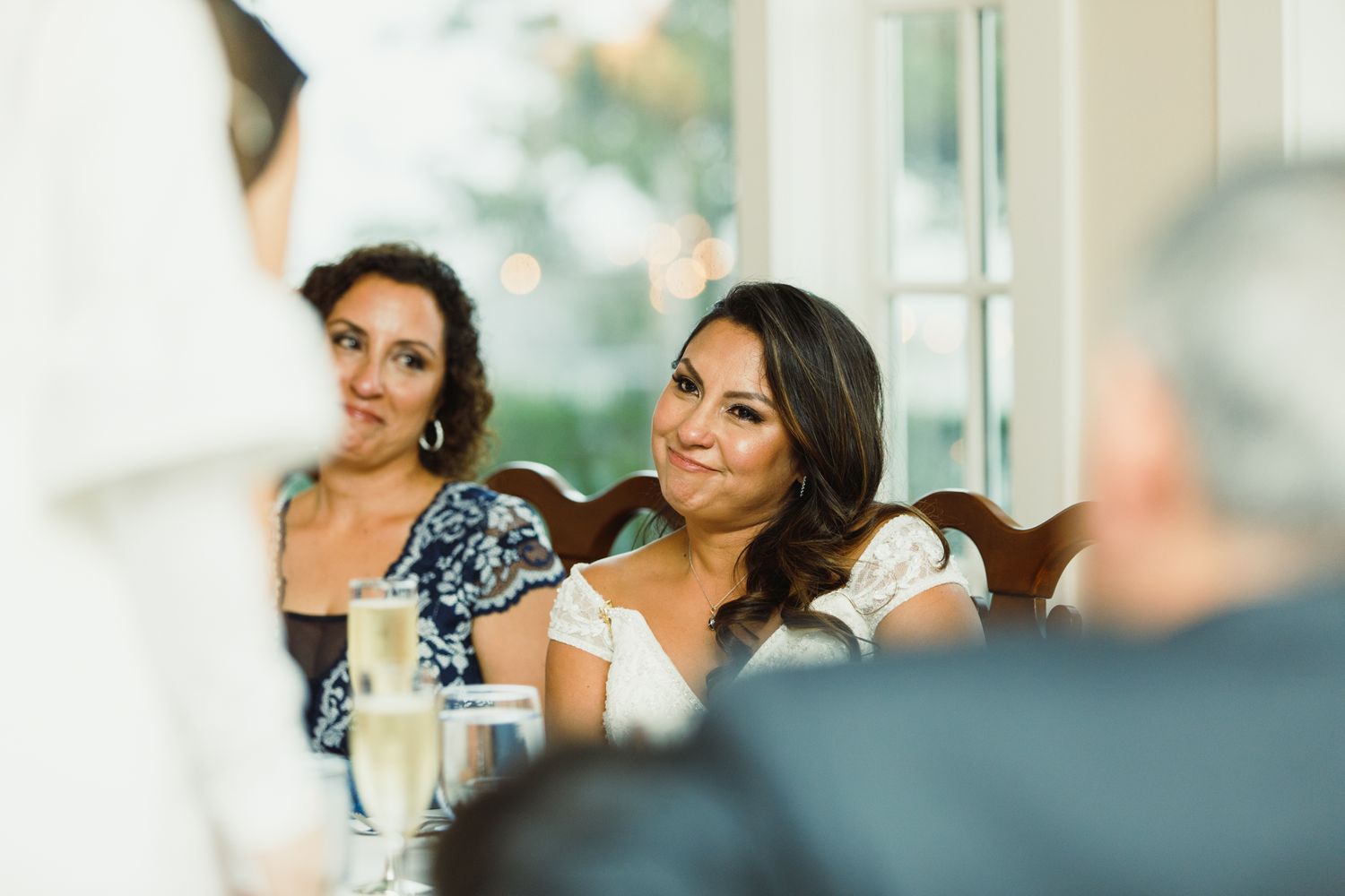 Natural light streams through windows during an elegant indoor celebration.