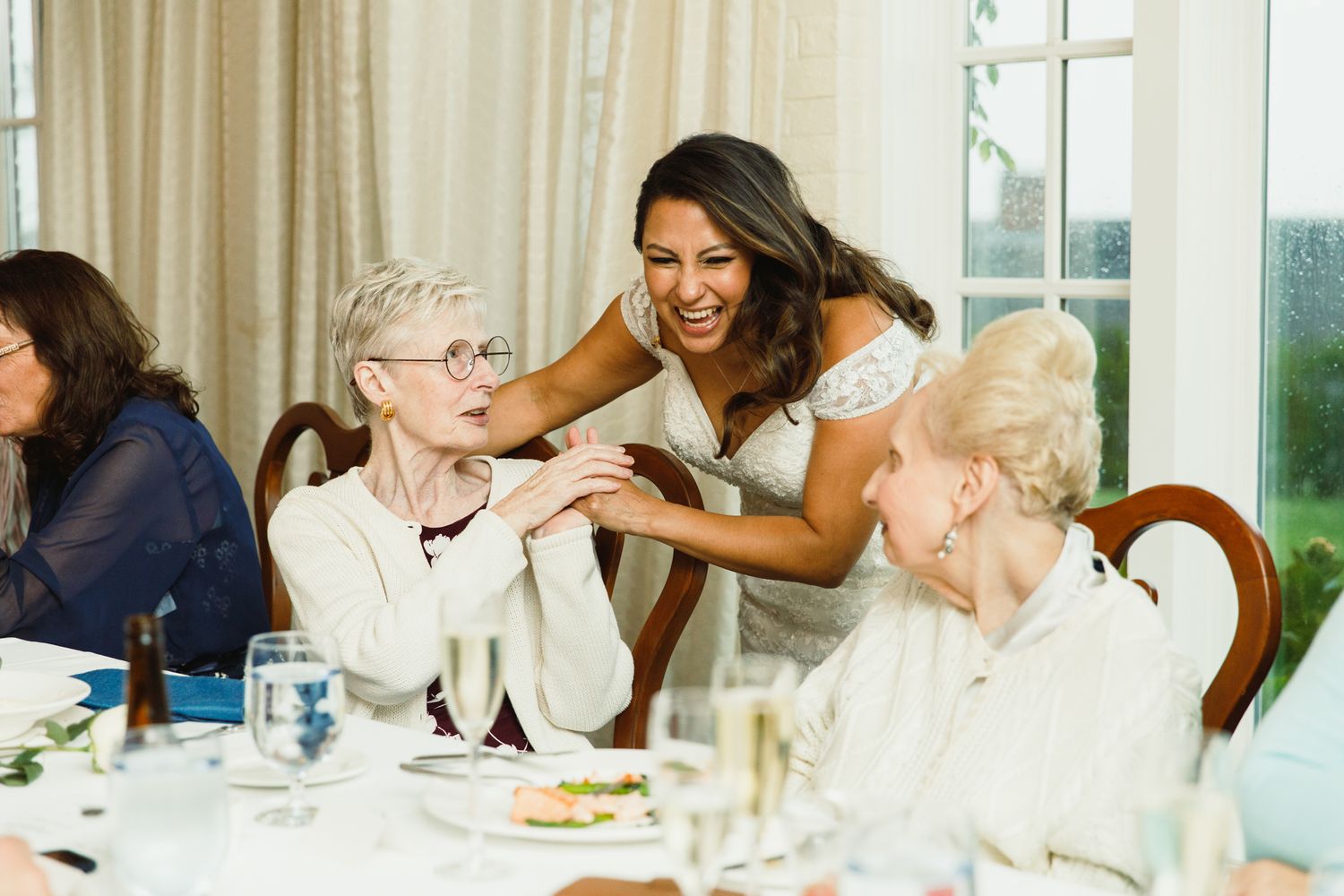 Joyful moments shared between guests at an elegant reception dinner.