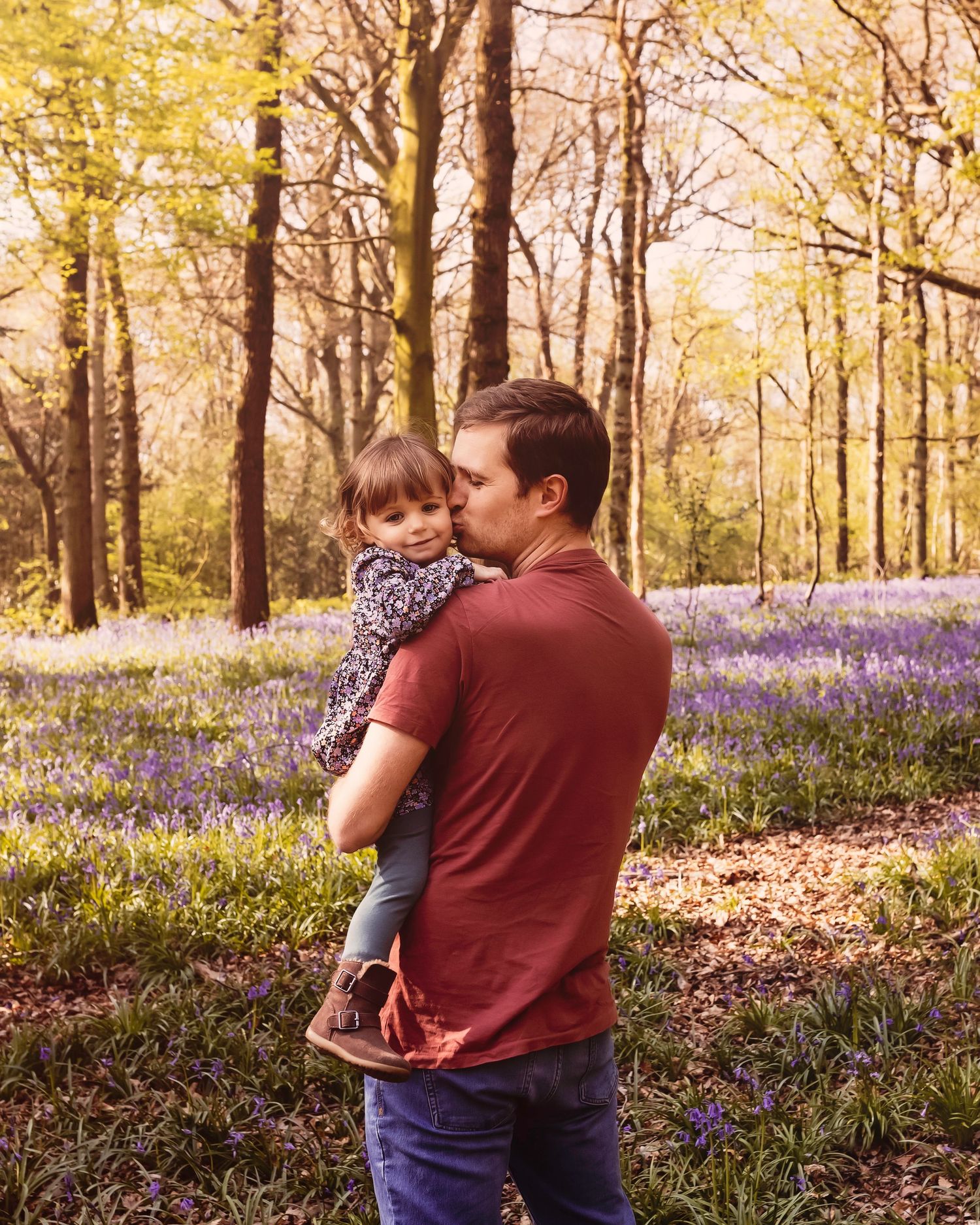 Serene moment in a woodland filled with bluebells on the forest floor during golden hour.