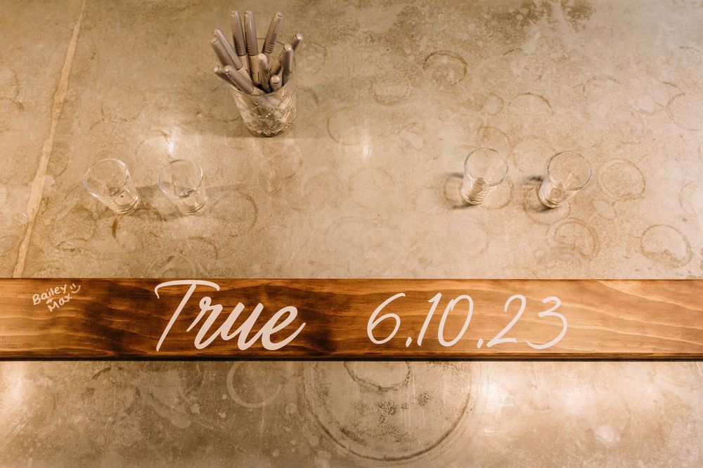 Rustic wooden wall with elegant script text overlay.