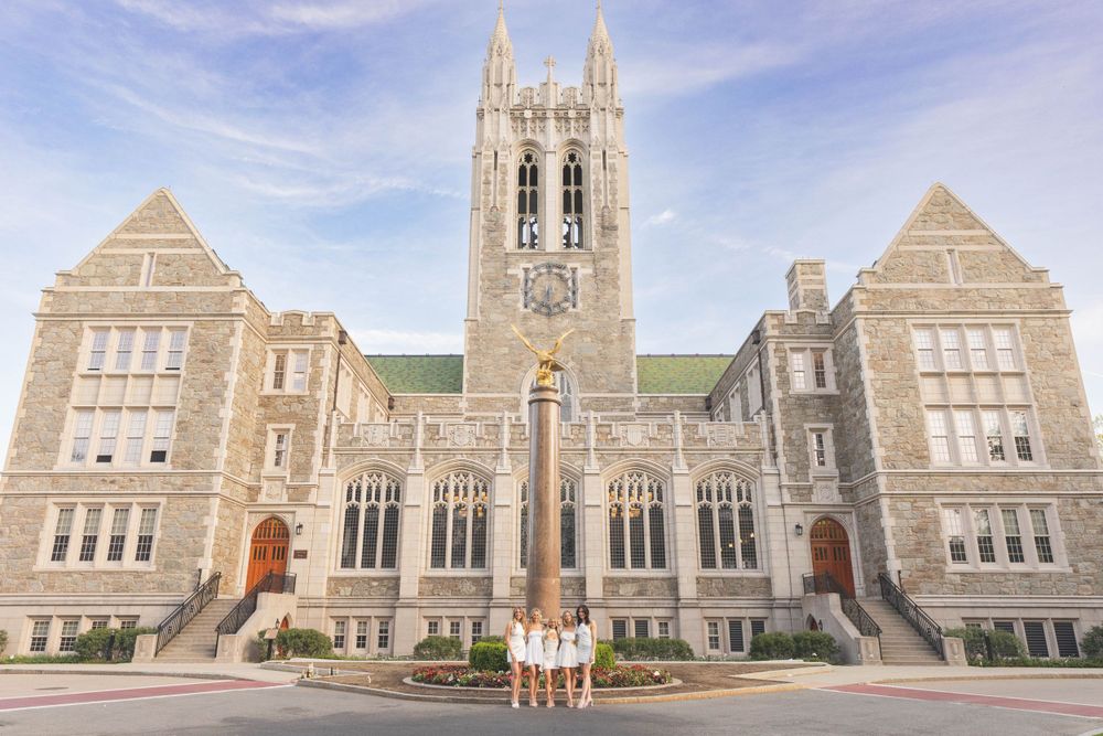 Gothic college building with ornate architecture and stone facade on a bright sunny day.