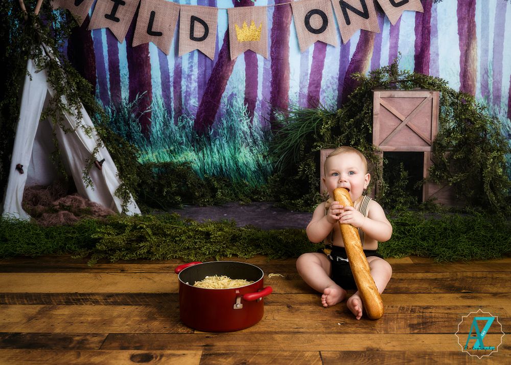 Wild One themed birthday setup with red bowl and forest-inspired backdrop creating magical atmosphere.