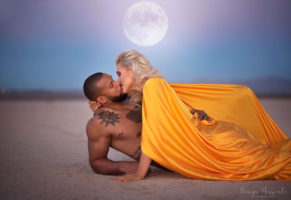 Romantic desert photoshoot with full moon and flowing yellow dress.