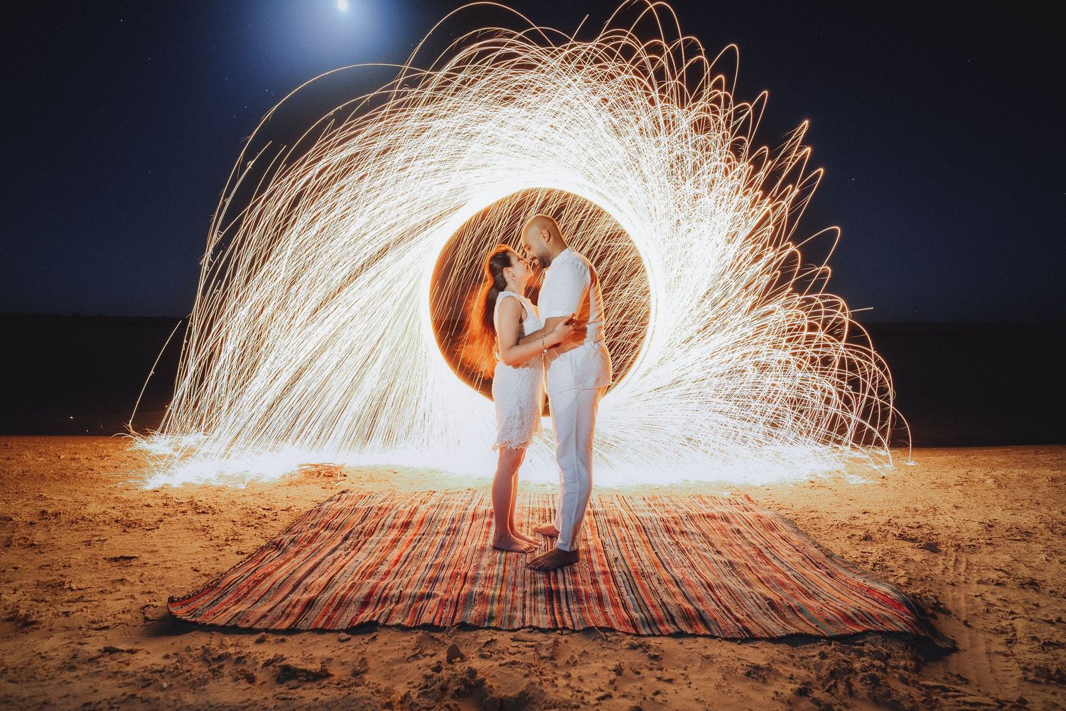 Long exposure photography creates circular light trails against a dark night sky.