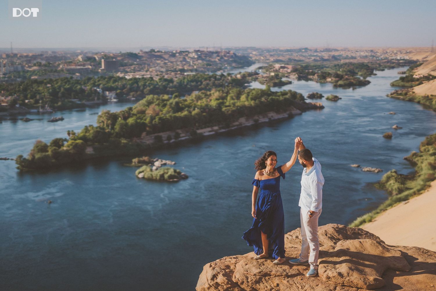 Scenic wedding photography overlooking a winding river landscape at sunset.