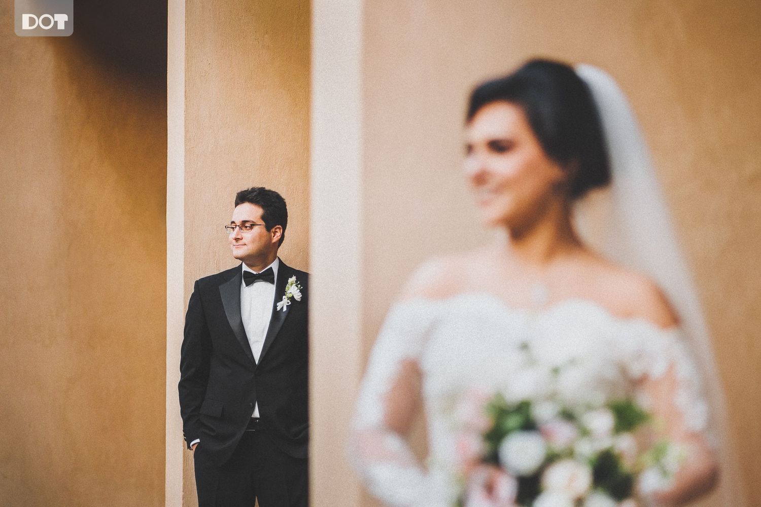Intimate indoor wedding portraits with warm lighting and neutral tones.