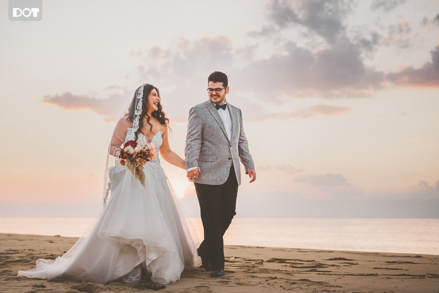 Romantic sunset beach portraits with couple dancing in soft evening light.
