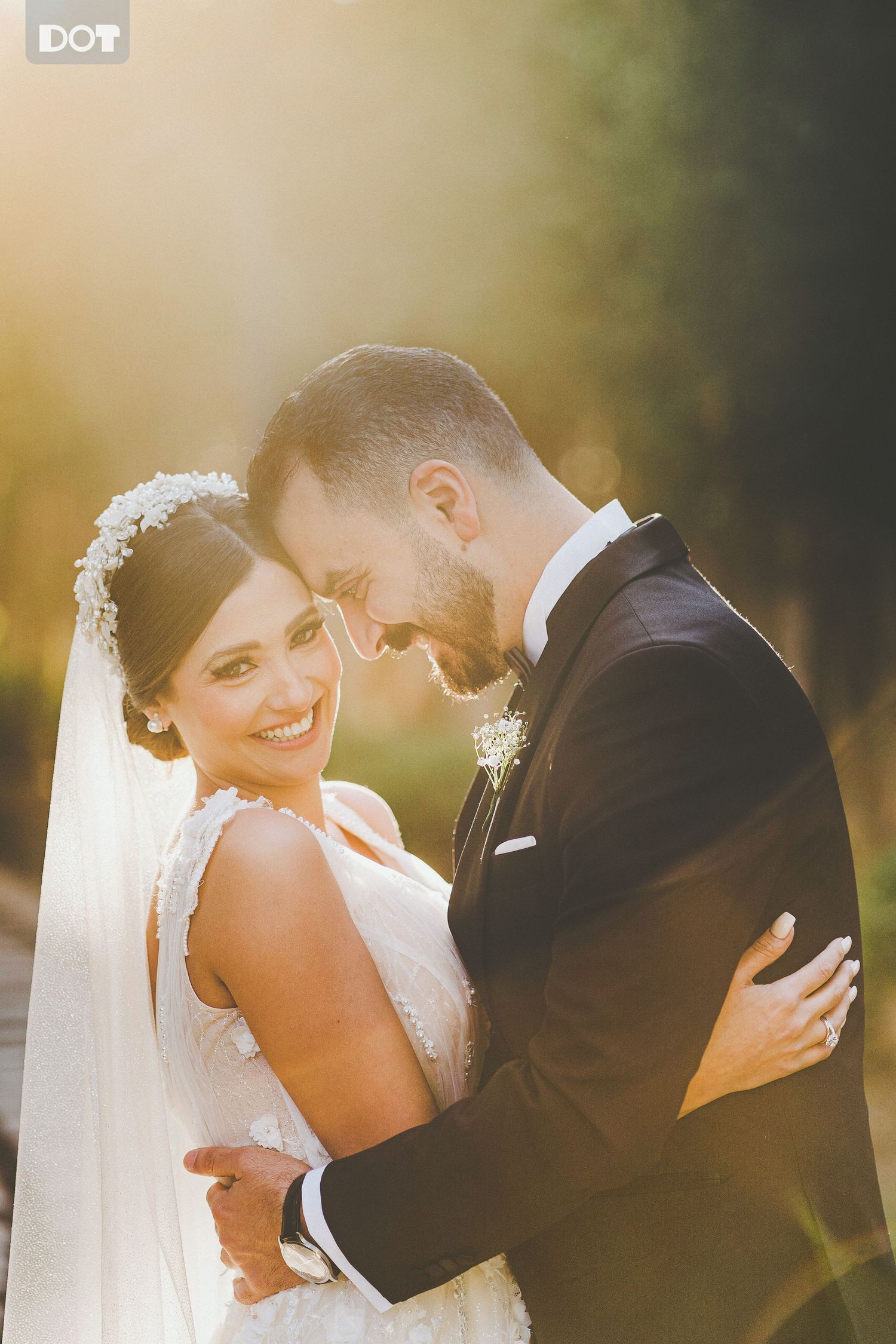 Golden hour wedding portraits with soft sunlight filtering through trees.