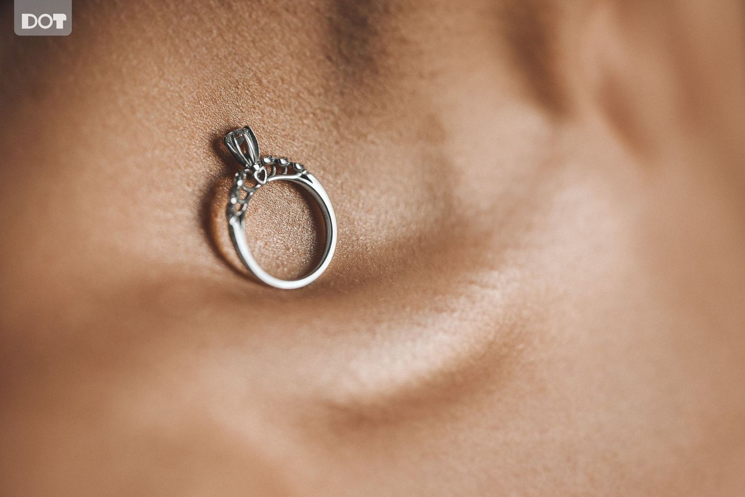 Close-up macro shots of wedding rings with soft brown background.