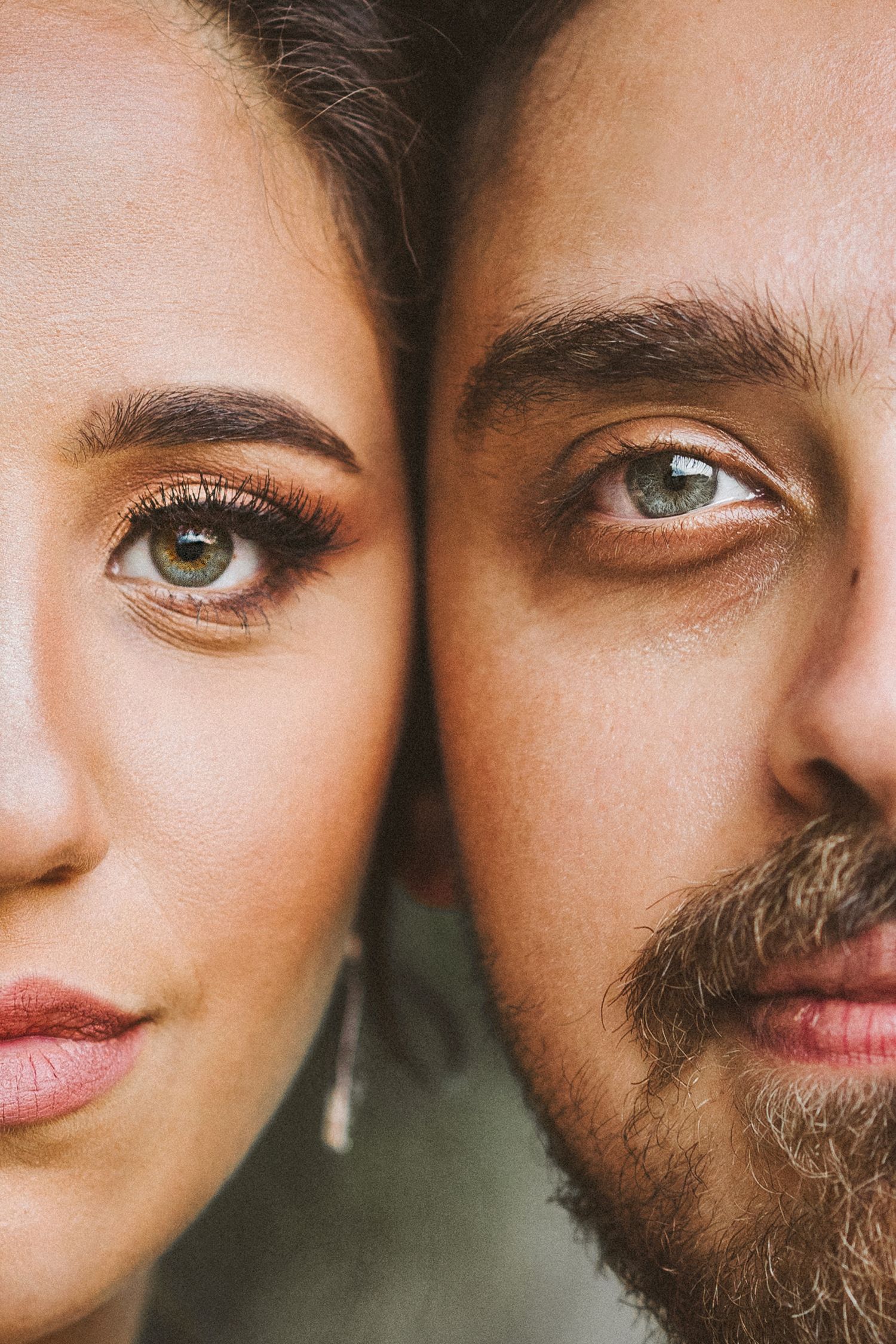 Artistic macro shot captures intimate wedding couple portrait with soft focus and natural lighting.