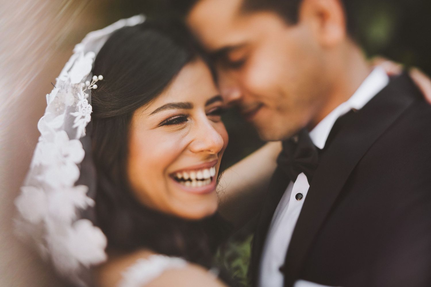 Romantic close-up of a couple sharing an intimate moment during their wedding photoshoot.
