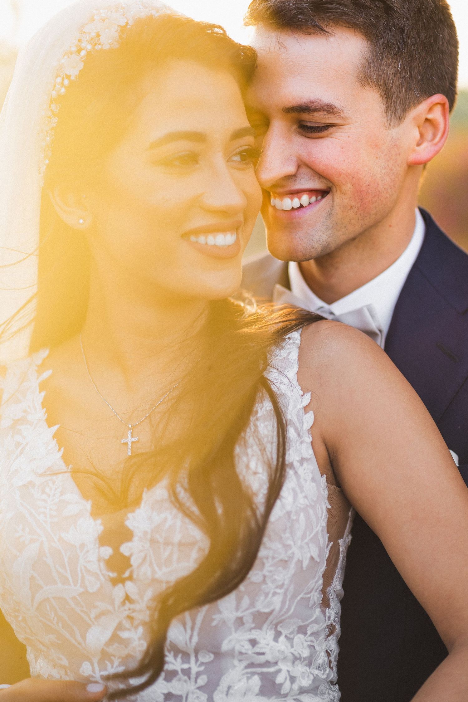 Romantic golden hour wedding portraits showing intimate moments between newlyweds.